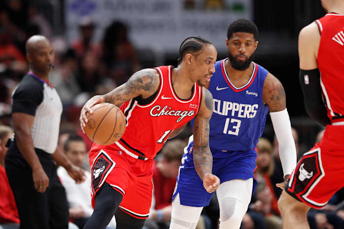 Mar 31, 2022; Chicago, Illinois, USA; Chicago Bulls forward DeMar DeRozan (11) drives to the basket against LA Clippers guard Paul George (13) during the first half at United Center